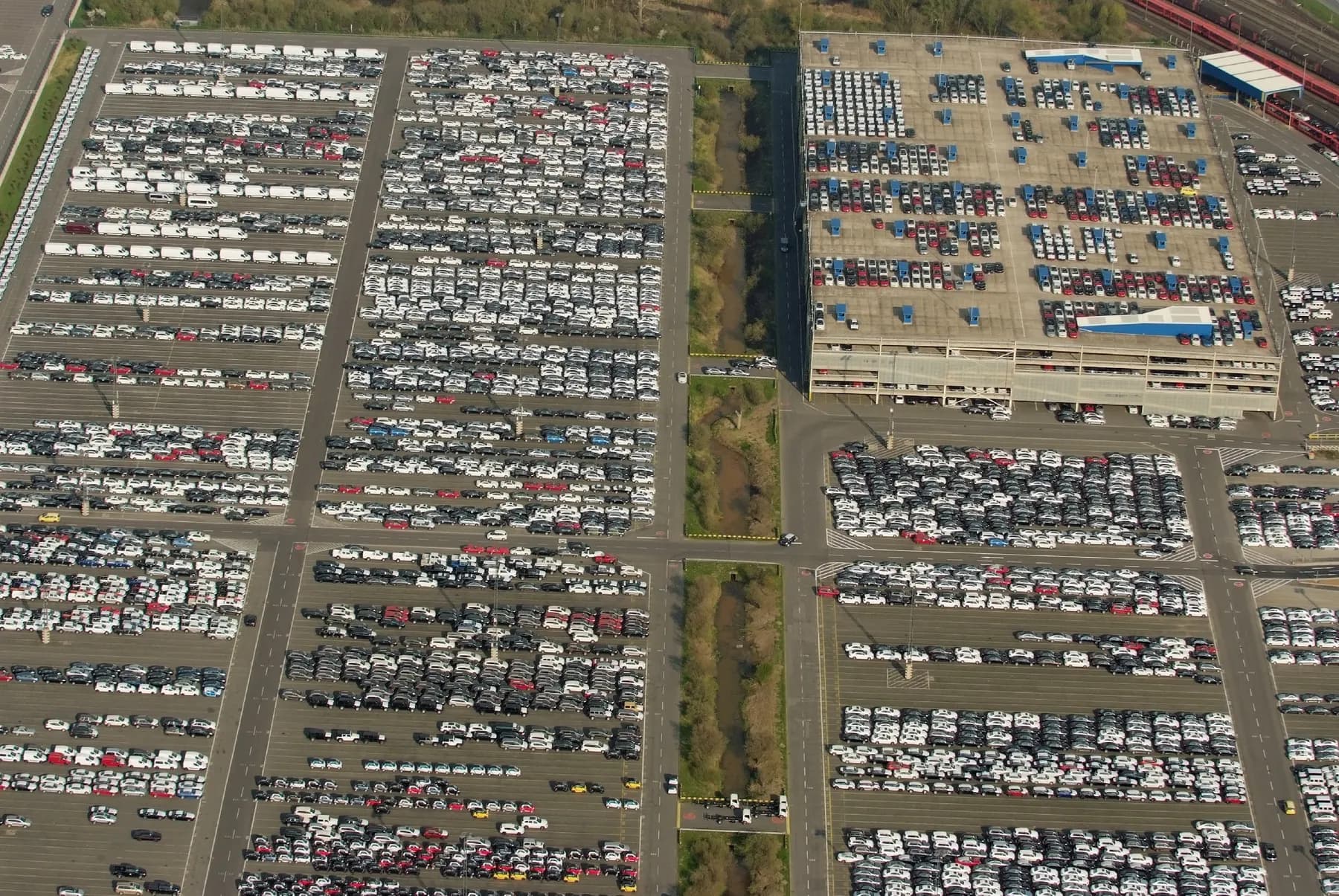 Thousands of cars lined up in rows at an export terminal